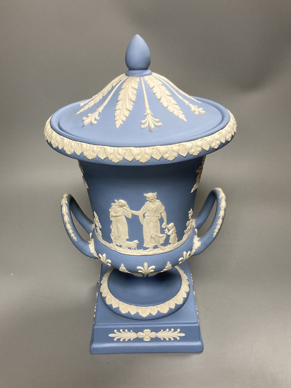 A 20th century Wedgwood light blue jasperware two-handled campagna-shaped urn and cover,